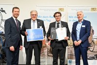 Gruppenfoto: Landrat Dießl und Ministerialdirektor Dr. Thomas Gruber überreichen Landrat Helmut Weiß und Radwegebeautragtem Sebastian Haser eine Urkunde